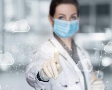 A doctor working in a network cloud data on blurred background. Photo credit: Natali _ Mis/Shutterstock